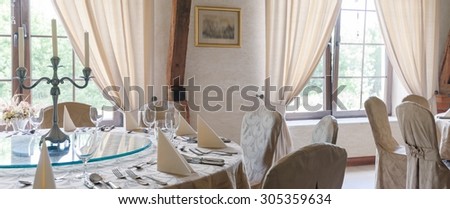 Setting of a table in hotel\'s restaurant dining room