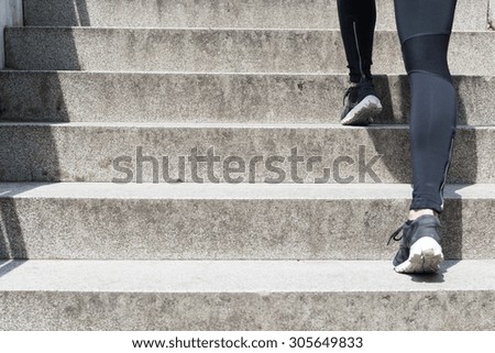 Close up of a female legs running up stairs