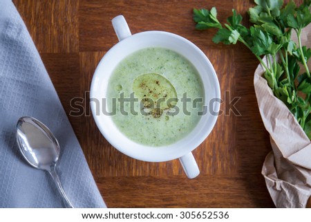 Delicious green vegetarian soup with parsley in posh restaurant
