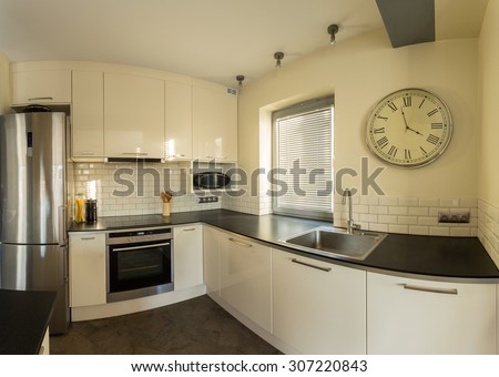 Retro wall clock in designed kitchen interior