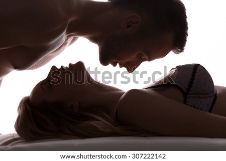 Sexy love couple in bed having foreplay