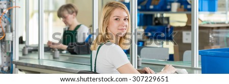 Pretty girl handles manual work in the factory