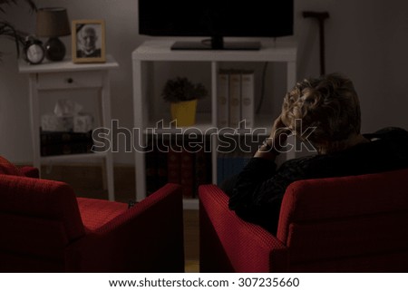 Lonely senior woman being alone at home