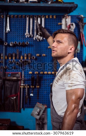 Image of car mechanic and professional automotive repair tools
