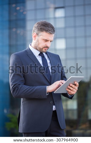 Picture of confident financial sector worker using laptop