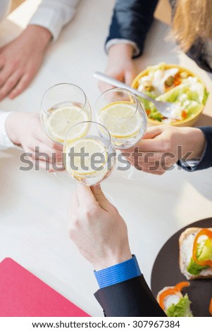 Close-up of coworkers hands during lunch time