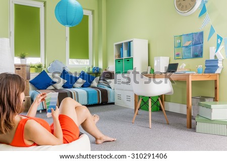 Photo of girl sitting on sack chair in teenager room