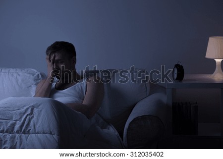 View of a man at night suffering from deep depression