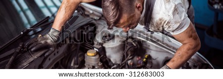 Horizontal view of automotive technician at work