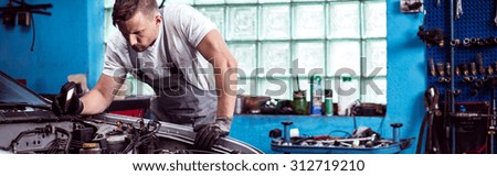 Man repairing a car in the garage
