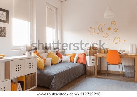 Yellow and orange accessories in modern teen room
