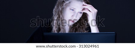 Teen victim of cyber bullying sitting at the desk