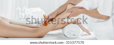 Panorama of female during legs manual lymphatic drainage massage