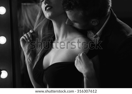B&w picture of affectionate couple during romantic foreplay