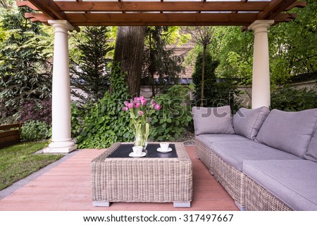 Picture of relaxation space in garden with elegant rattan furniture