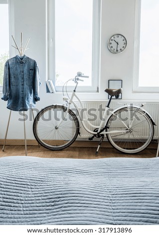 Modern bicycle and denim shirt in the bedroom