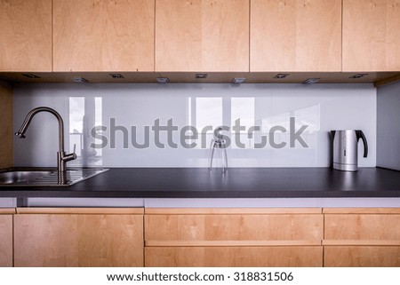 Wooden kitchen unit in stylish contemporary interior