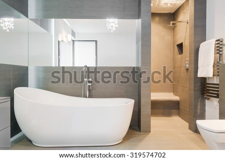 Photo of big new design bathtub in spacious trendy bathroom