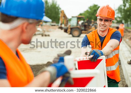 Close up of builders working along on construction site
