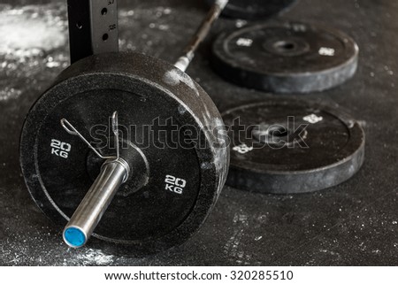 Close-up of heavy barbell on the gym floor