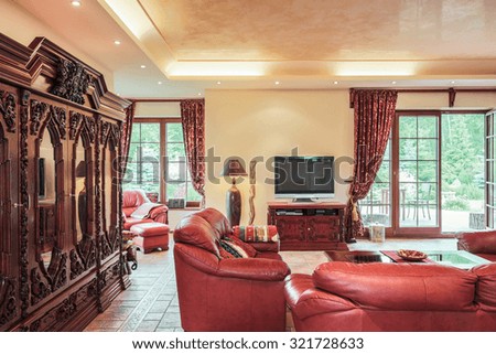 Image of spacious cosy lounge with antique wooden closet