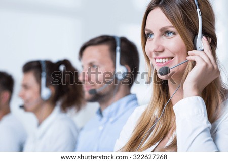 Smiling customer service representative talking with client