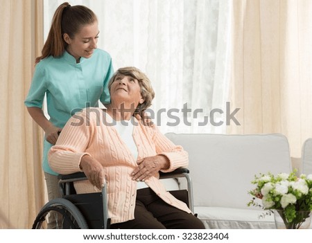 Nurse discussing with elder patient in care home