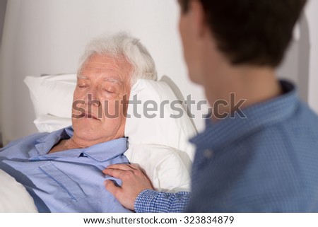 View of an elder man falling asleep and his relative