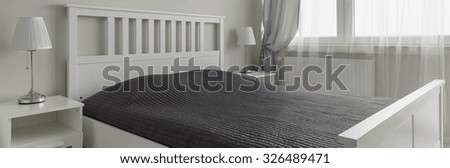 Panoramic view of bed in master bedroom of avant-garde couple