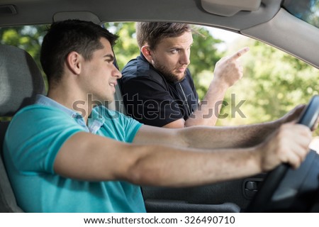 Helpful cop showing the right direction to lost driver