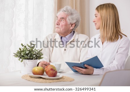Picture of caring daughter visiting her old father