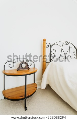 Wooden bed and nightstand with ornamental iron elements