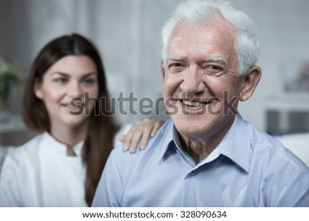 Young nurse is spending time with elder man