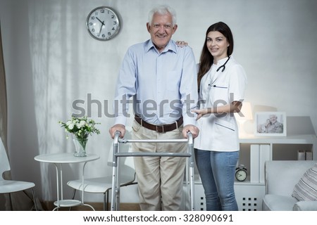 Young doctor is helping elder and lonely man
