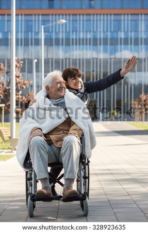 Social worker taking disabled man for a walk