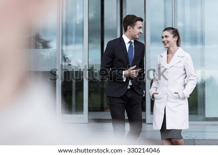 Attractive business man and woman talking after work