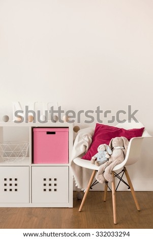 Photo of white cabinet and chair in child bedroom