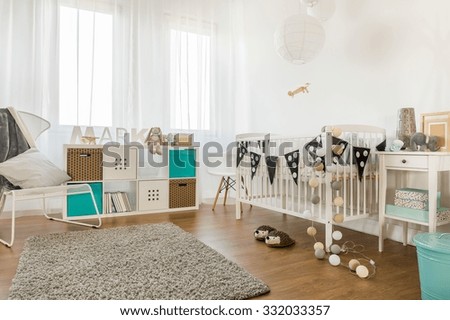 Image of spacious infant bedroom with white furniture