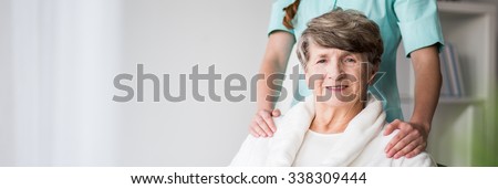 Elderly woman in nursing home and nurse