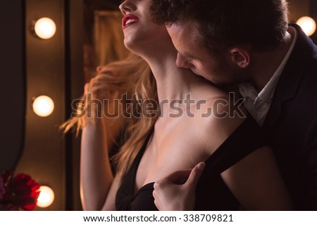 Horizontal picture of mature man kissing beautiful woman\'s neck