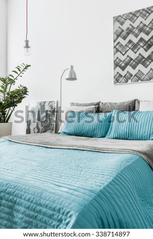 Photo of turquoise decorative bedding in new bedroom