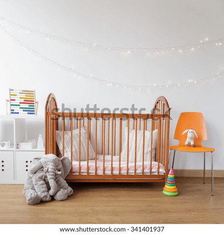 Image of child room with wooden crib and pink carpet