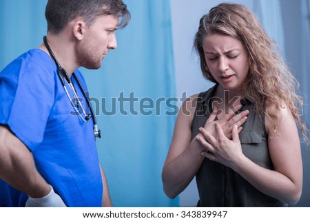Young doctor interviewing woman in emergency room