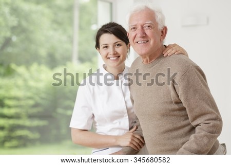 Young nurse taking care of old sick man
