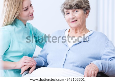 Photo of senior rich lady and her positive carer