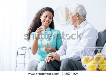 African American doctor caring about elder person