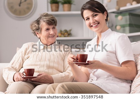 Image of private caregiver and senior female smiling