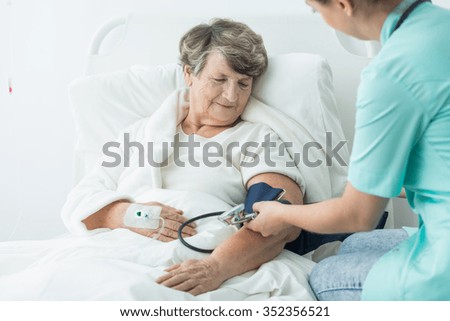 Photo of geriatric ward patient with hypertension and nurse
