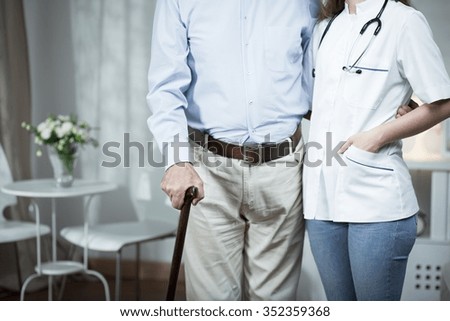 Elder man and his nurse - photoshoot below head