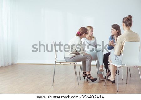 Four women talking in group about problems